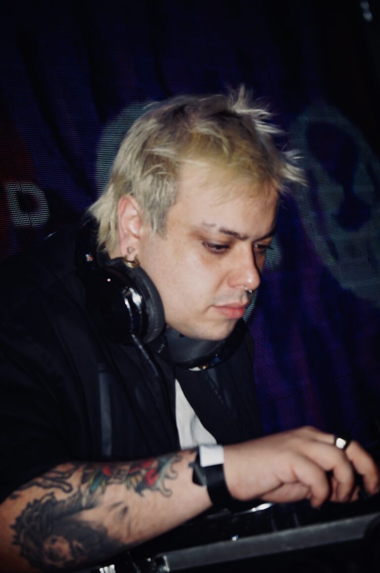 DJ de cabelo platinado e fones de ouvido — Sad Baile Joker, Halloween em São Paulo, 17/10/2026