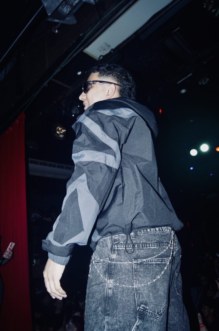 Rapper de jaqueta cinza de costas no palco — Sad Baile Joker, Halloween em São Paulo, 17/10/2026