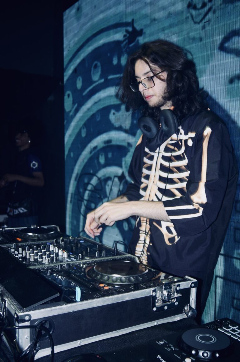 DJ de jaqueta de esqueleto diante do telão em espiral — Sad Baile Joker, Halloween em São Paulo, 17/10/2026
