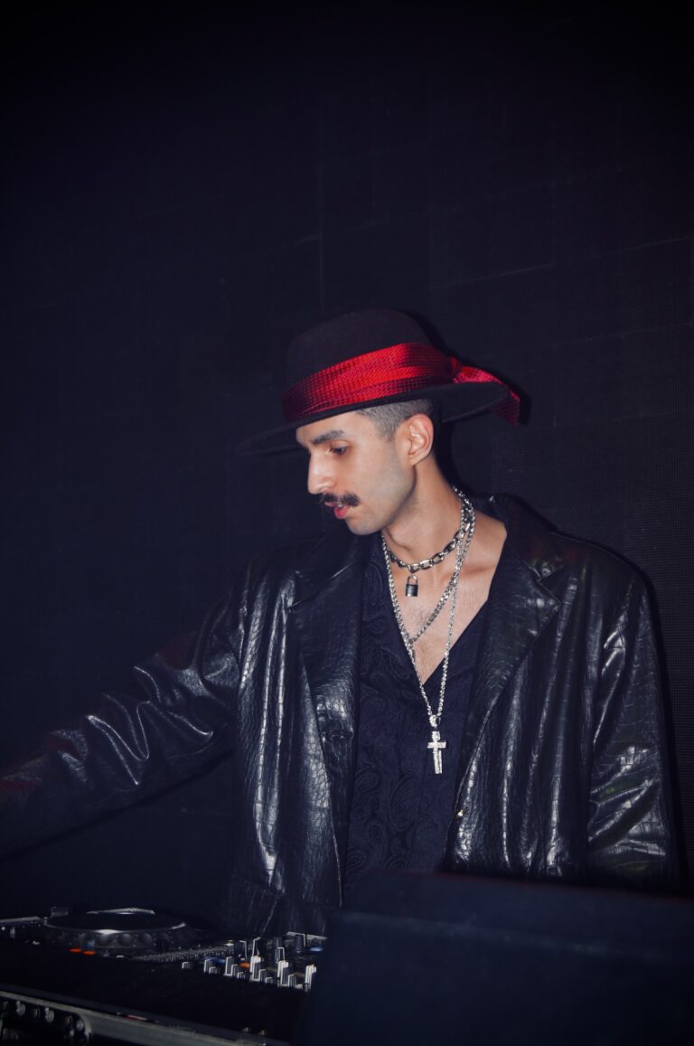 DJ de chapéu e colar de crucifixo nos controles — Sad Baile Joker, Halloween em São Paulo, 17/10/2026
