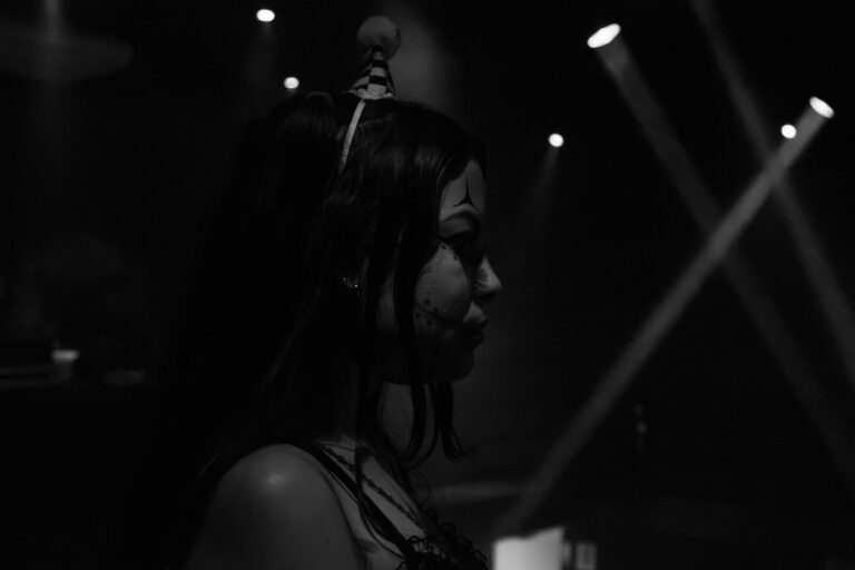 Garota em preto e branco sob feixes de luz — Sad Baile Joker, Halloween em São Paulo, 17/10/2026