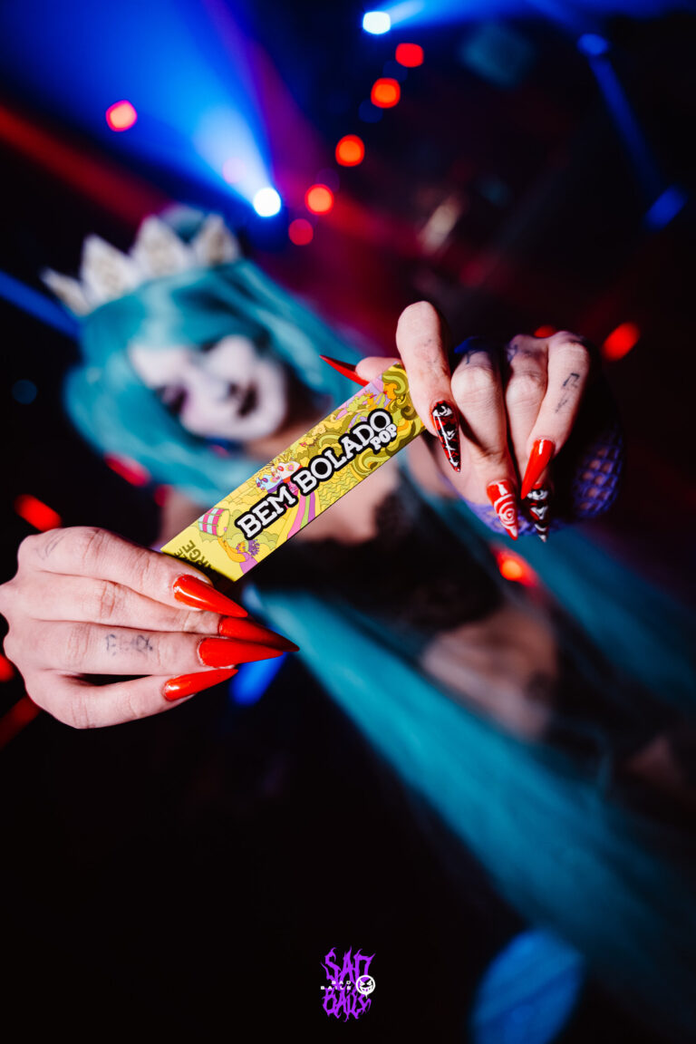 Unhas vermelhas seguram seda Bem Bolado — Sad Baile Joker, Halloween em São Paulo, 17/10/2026