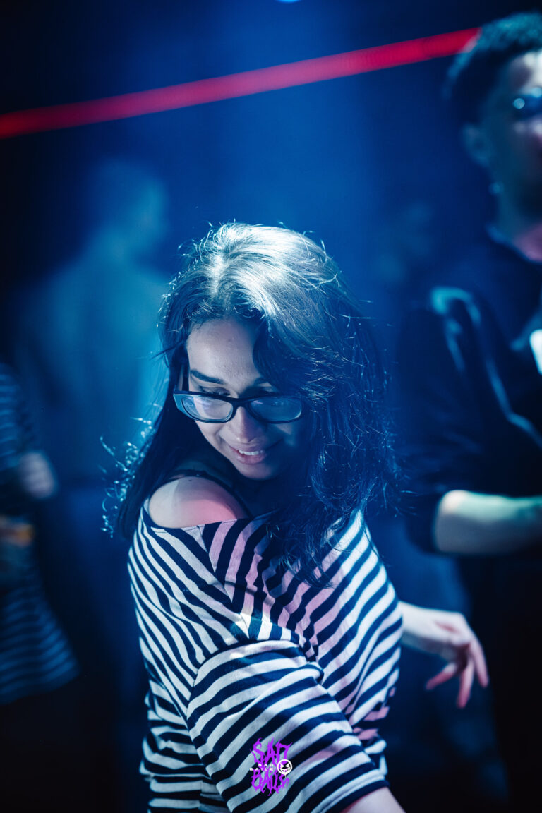 Garota de blusa listrada sorri na pista — Sad Baile Joker, Halloween em São Paulo, 17/10/2026